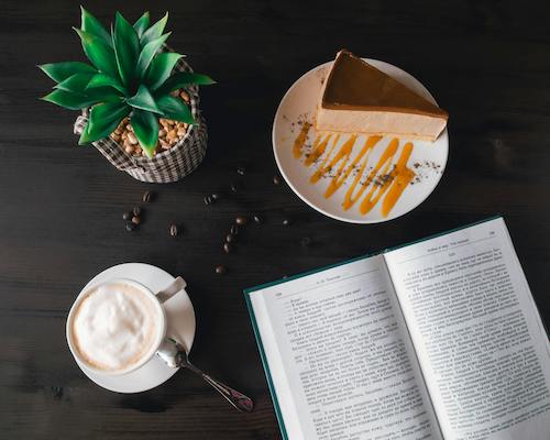 A cozy coffee and book scene representing the personal stories and smart living tips of Daisylog.