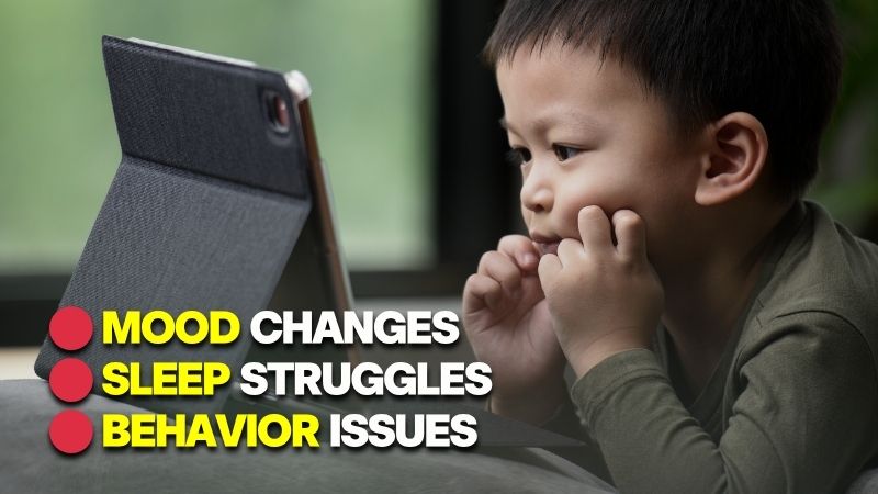 A young child focused on a digital screen, illustrating the impact of screen time and young children's development.