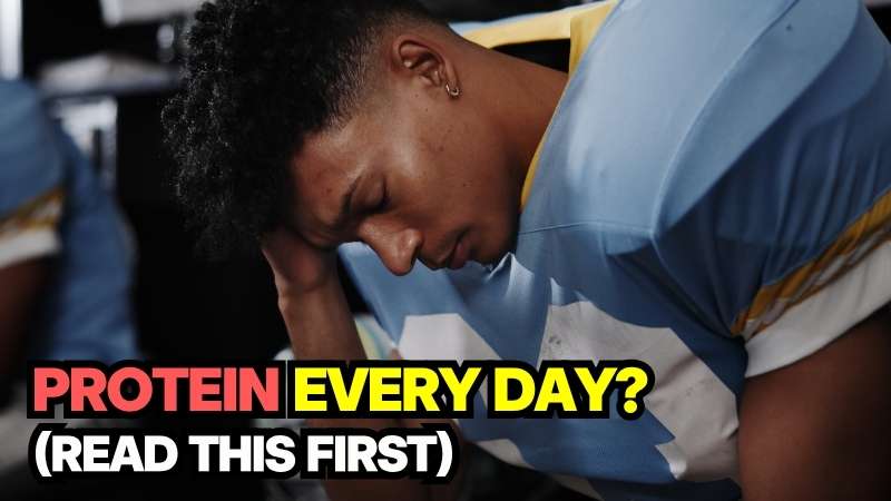 A person feeling physical discomfort or bloating illustrating the potential side effects of consuming protein at every meal